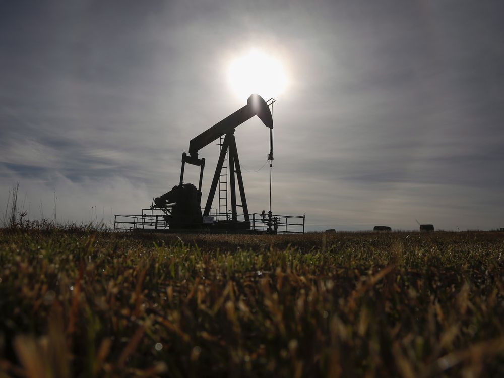  A pumpjack works at a well head on an oil and gas installation near Cremona, Alberta.