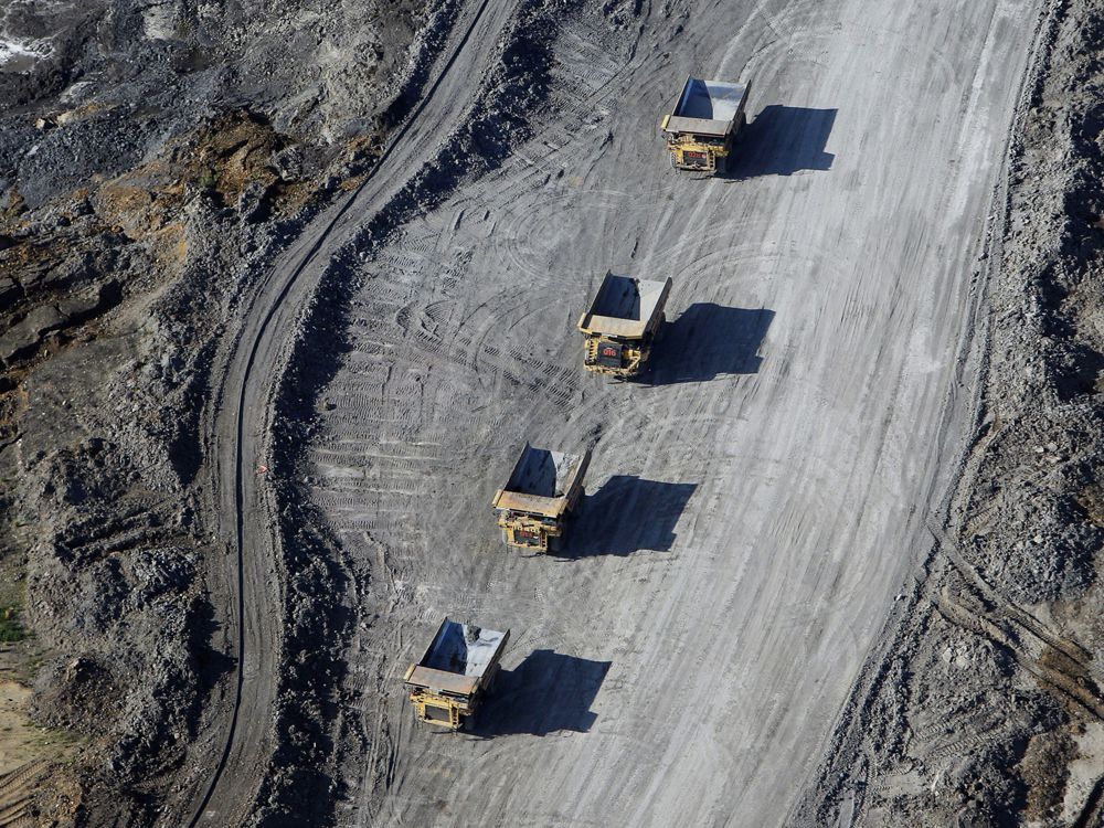  Dump trucks carrying oilsands at a Suncor Energy mine.