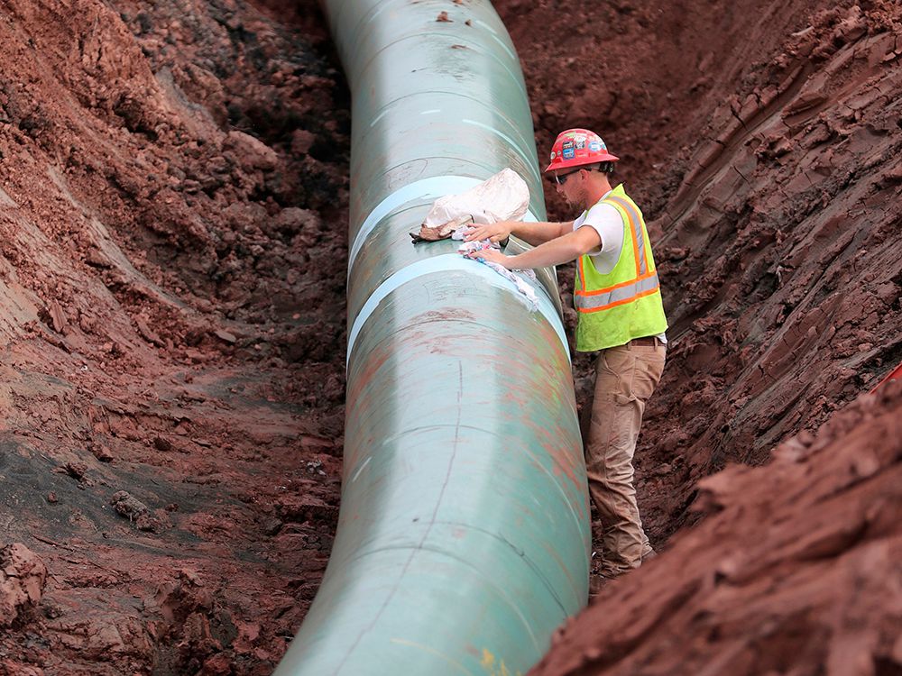  A pipe fitter lays the finishing touches to the replacement of Enbridge Energy’s Line 3 crude oil pipeline stretch in Superior, Minn., in 2017.