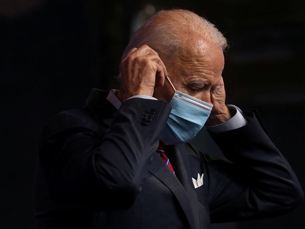  U.S. President-elect Joe Biden puts a mask on as he leaves the lectern after making remarks about the economy and the final U.S. jobs report of 2020 at his transition headquarters in Wilmington, Delaware, U.S., December 4, 2020.