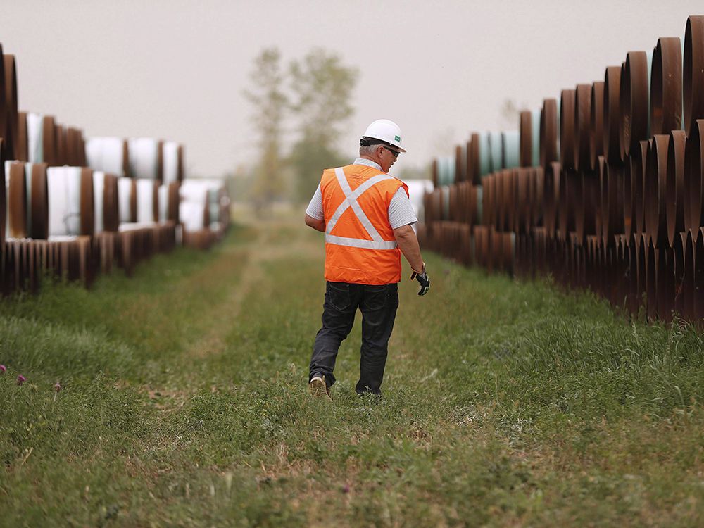  Les Scott, Senior Community Advisor for Enbridge walks through a oil pipe storage facility just west of Morden, Man., Thursday, Aug. 16, 2018. A press conference and tour of a Line 3 site for federal, provincial, municipal and indigenous leaders was held at the site. 