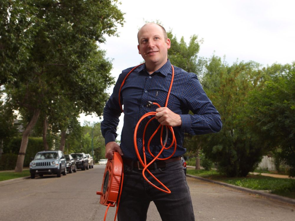  Blake Shaffer poses outside his northwest Calgary home on Wednesday, July 18, 2018. Shaffer is an economist who specializes in electricity usage trends.