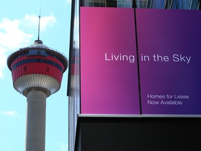 The Calgary Tower is framed with the signage on the Telus Sky building advertising residential units on Monday, April 26, 2021.