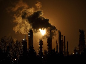 A flare stack lights the sky from the Imperial Oil refinery in Edmonton on Dec. 28, 2018.