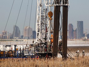 A drill crew works on a rig near the Calgary city limits.
