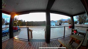 A still image from a doorbell camera shows floodwaters surrounding a property in Merritt, British Columbia, Nov. 15, 2021.