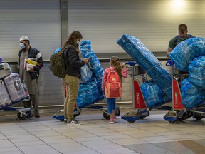 People line up to get on an overseas flight at OR Tambo’s airport in Johannesburg, South Africa, on Friday, Nov. 26, 2021.