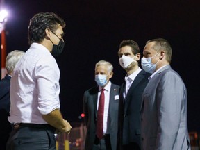 Prime Minister Justin Trudeau greets Michael Kovrig and Michael Spavor in Calgary after their release.