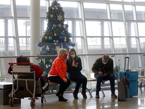 Air travellers during the Christmas rush at the Calgary International Airport in Calgary on Tuesday, December 14, 2021.