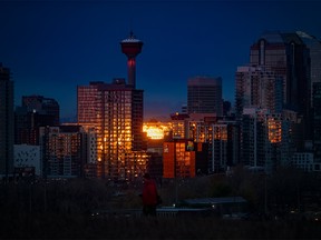 The sunrise reflects off the downtown Calgary skyline on Thursday, October 28, 2021.