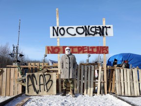 Supporters of the Wet'suwet'en Nation's hereditary chiefs camp at a railway blockade as part of protests against British Columbia's Coastal GasLink pipeline, in Edmonton, Feb. 19 2020.