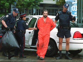 Steven Guilbeault is taken into custody by police after scaling the CN Tower in 2001 during his time as a Greenpeace activist.