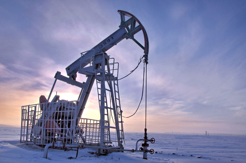 Pump jack in the winter morning's sunrise.