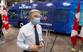 Federal minister of industry Francois-Philippe Champagne tours walks past a new electric bus during a tour of the Novabus plant in 2021 in St. Eustache, Quebec.