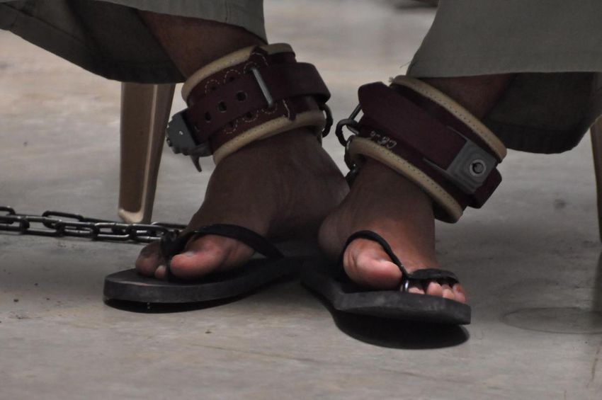 A detainee is shackled while participating in a "Life Skills" class taught inside the U.S.-run prison at Guantanamo Bay, Cuba, in 2010.