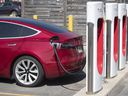 A Tesla car is charged at the Tesla Supercharger station at a shopping mall in Kingston, Ont., on July 7, 2020. 