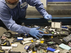 A worker sorts batteries at the Li-Cycle lithium-ion battery recycling facility in Kingston, Ont.