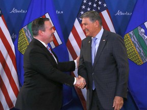 United States Senator Joe Manchin of West Virginia and Alberta Premier Jason Kenney speak to media during the senator’s visit at the McDougall Centre in Calgary on Tuesday, April 12, 2022.