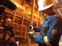 Drew Zieglgansberger, executive vice-president of natural gas and technical services at Cenovus Energy, shows the molasses-like consistency of bitumen during a media tour at the Christina Lake facility in 2011.