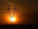 The sun sets as the sky gives off a redish glow behind power lines along the Anthony Henday Dr. in Edmonton, May 5, 2021.