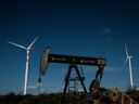 An oil drilling platform is seen next to wind turbines at Vamcruz Windfarm in Serra do Mel, Rio Grande do Norte State, Brazil. 