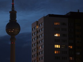 The broadcast tower at Alexanderplatz stands without illumination behind an apartment building in Berlin on Sept. 8. Germany is facing uncertain times as it seeks to pivot away from Russian gas, oil and coal.