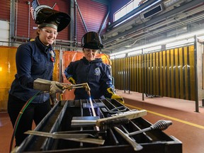 Instructor Kayla Vander Molen, left, shows Finance Minister Chrystia Freeland the finer points of welding at the International Brotherhood of Boilermakers lodge.