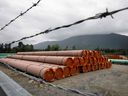 Pieces of the Trans Mountain Pipeline project sit in a storage lot outside of Hope, British Columbia this past June. Volatile weather and the pandemic have slowed construction. 
