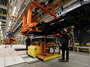 Employees works on the line at automaker General Motors’ Brightdrop unit’s CAMI EV Assembly, Canada’s first full-scale electric vehicle manufacturing plant, in Ingersoll, Ont.