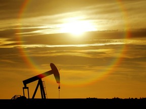 An oil well pumps against the setting sun outside of Drumheller.