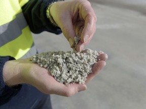 A worker holds processed lithium at a facility in Australia.