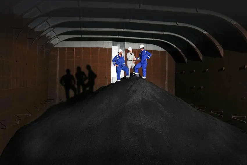 Gerard Barron with Allseas crew members stand on about 3,000 tonnes of nodules in the hold of the Hidden Gem ship while at port in Manzanillo, Mexico, November 2022.