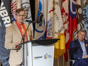 Justin Bourque, President, Athabasca Indigenous Investments, speaks at the announcement of a deal between Enbridge and 23 First Nations and Metis communities as Al Monaco, then-President and CEO of Enbridge listens. Taken on Wednesday, Sept. 28, 2022 in Edmonton.
