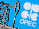 FILE PHOTO: A 3D printed oil pump jack is seen in front of displayed OPEC logo in this illustration picture, April 14, 2020. 