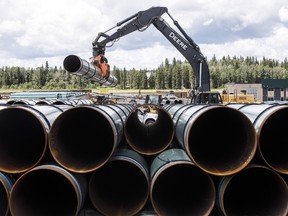 Pipe for the Trans Mountain pipeline is unloaded in Edson, Alta. on Tuesday June 18, 2019.