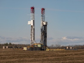 Two rigs work at a drilling site west of Wembley, Alta.
