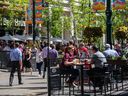 People spend the sunny lunch hour in the patios on Stephen Avenue as restaurant reopen for outdoor dining on Tuesday, June 1, 2021. 