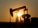 An oil pump jack pumps oil in a field near Calgary on July 21, 2014.