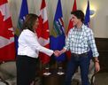 Premier Danielle Smith and Prime Minister Justin Trudeau shake hands in Calgary on Friday, July 7, 2023.