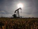 A pumpjack works at a well head on an oil and gas installation near Cremona, Alta.