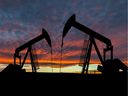 Dramatic sky over two pumpjacks in rural Alberta, Canada.